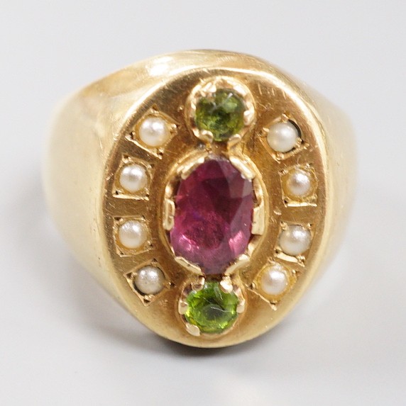 A gold (tests as 18ct), three stone two colour garnet and split pearl cluster set oval dress ring, size V, gross weight 21.7 grams.